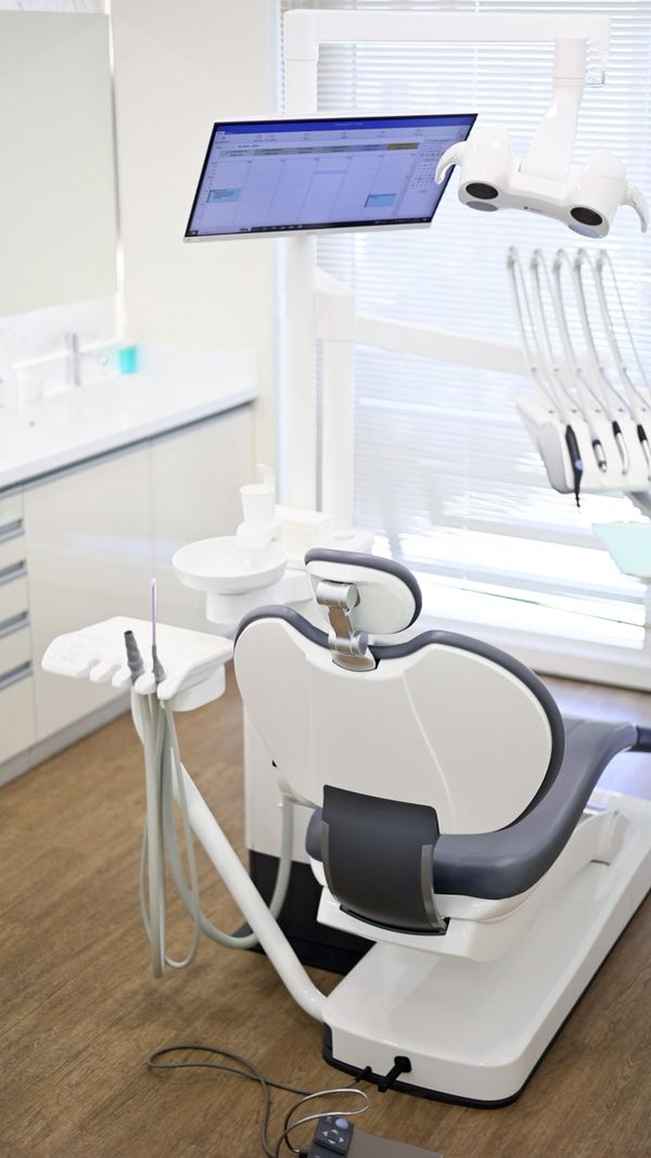Patient Chair in an All white treatment room in Modern Dental Clinic 