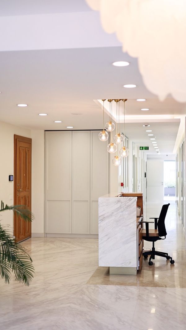 Bright Reception Area with Marble floors and accents in Dental clinic